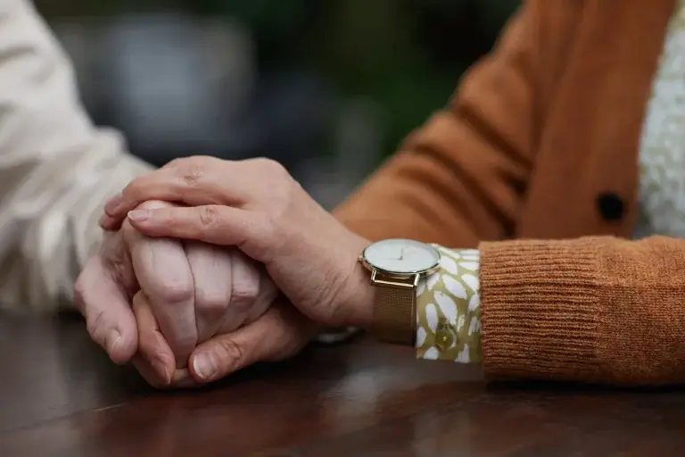 a senior couple holding hands