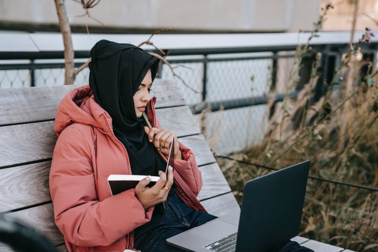 a smiling woman with a laptop